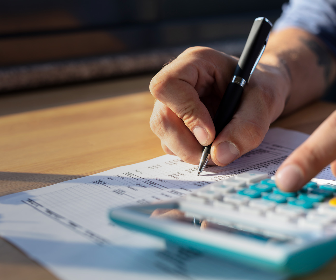 Mann rechnet mit Taschenrechner